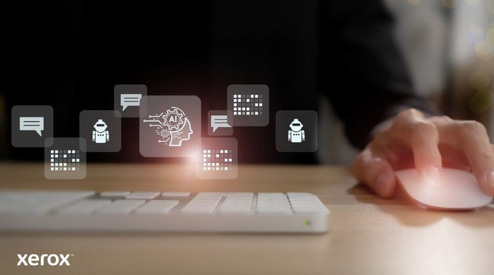 La main d'une personne est pos&eacute;e sur une souris d'ordinateur, avec des ic&ocirc;nes lumineuses abstraites li&eacute;es &agrave; la communication, &agrave; l'IA et au traitement des donn&eacute;es flottant au-dessus du clavier, repr&eacute;sentant des fonctionnalit&eacute;s de documents intelligents.